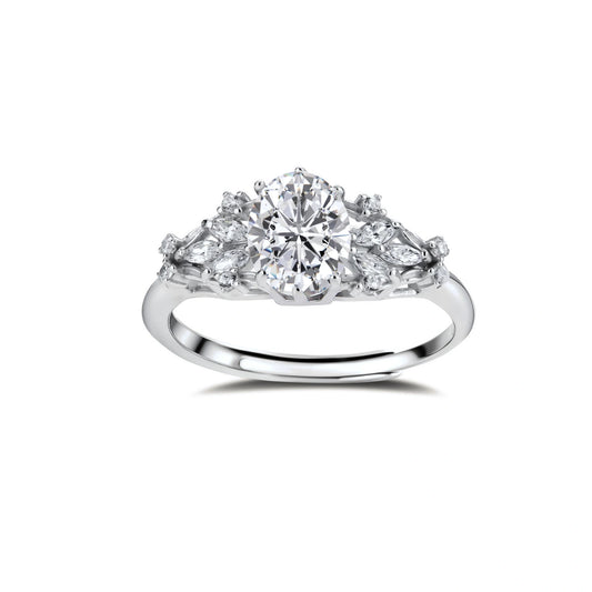 Sterling silver ring with oval moissanite center stone surrounded by smaller accent stones in ornate setting