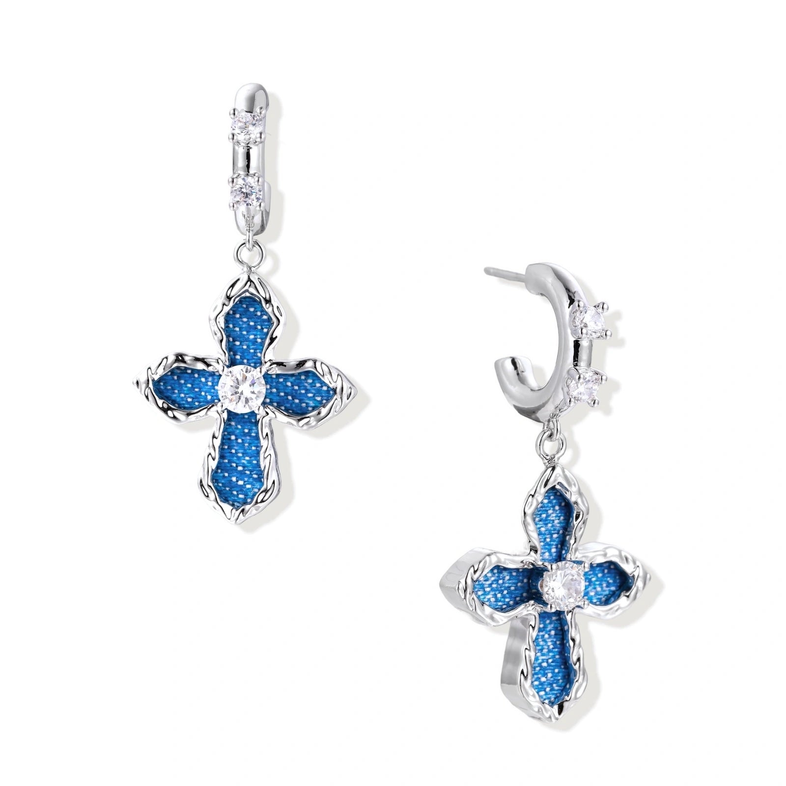Silver hoops with denim-inlaid cross charms and clear crystals on beige background