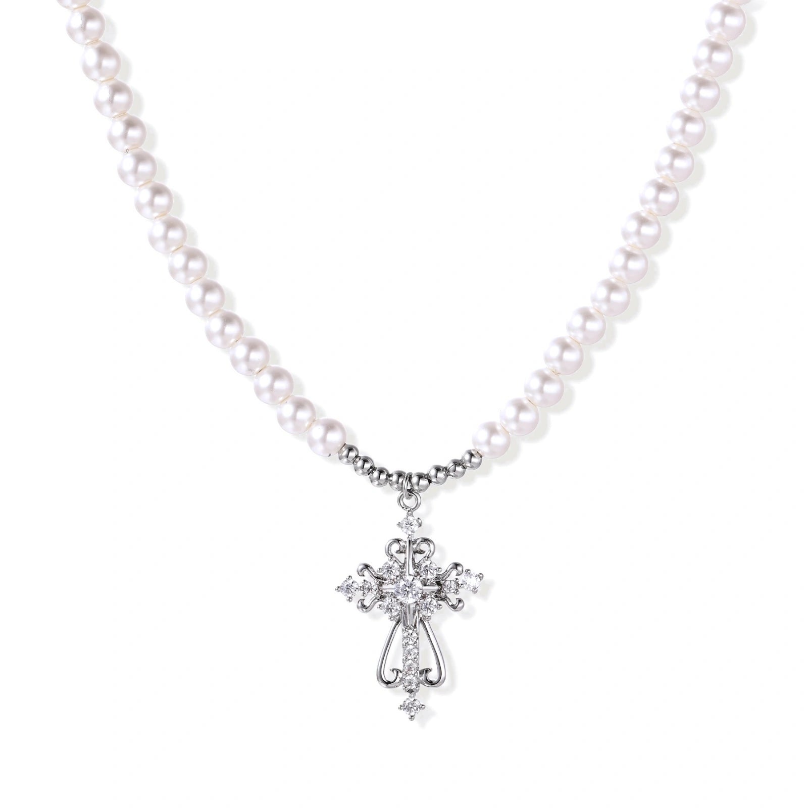 White pearl necklace with ornate silver cross pendant featuring zirconia crystals on cream background.